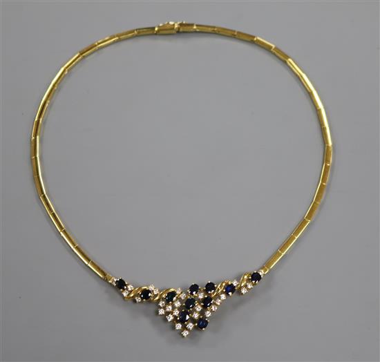 A modern 18ct gold sapphire and diamond cluster set necklace.